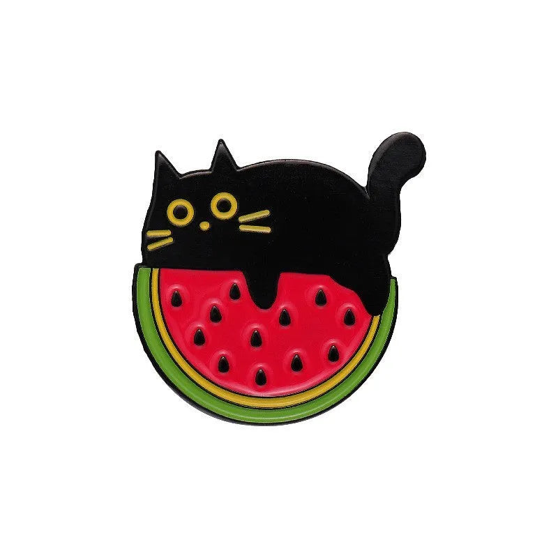 Colourful cartoon-style fruit metal brooch with pin back on a denim jacket lapel.