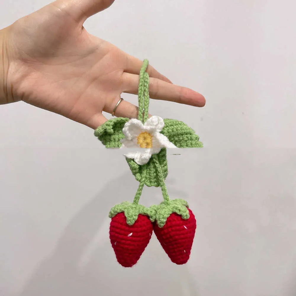 Handmade strawberry-shaped car pendant made from cotton and hemp knitting wool.