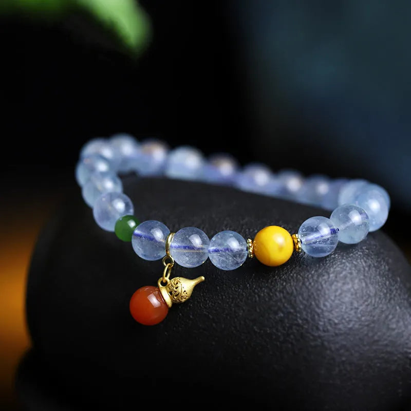 Iced aquamarine crystal bracelet with geometric arrangement of 8mm stones and adjustable cord