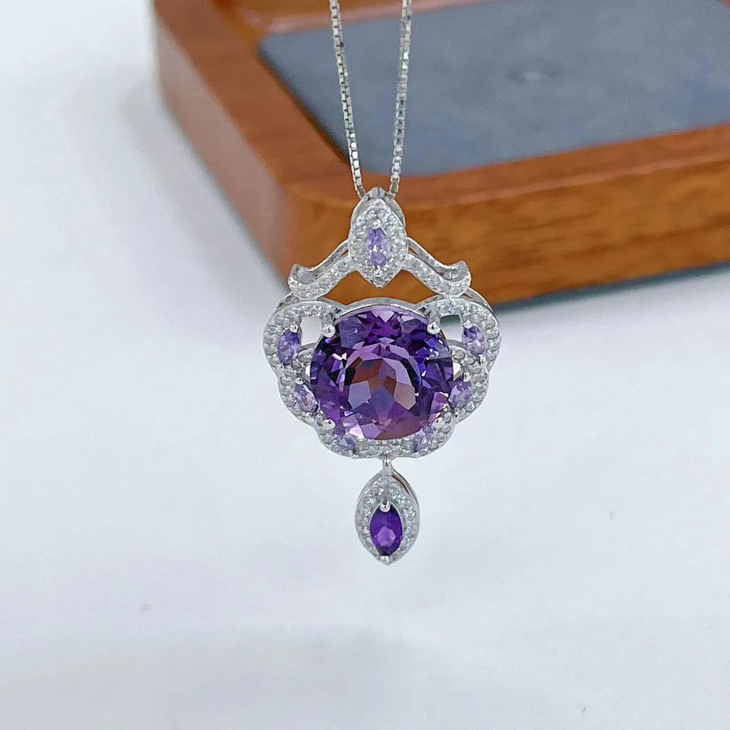 Close-up of a purple amethyst gemstone set in a U-shaped platinum-plated S925 silver pendant with meteor shower detailing.