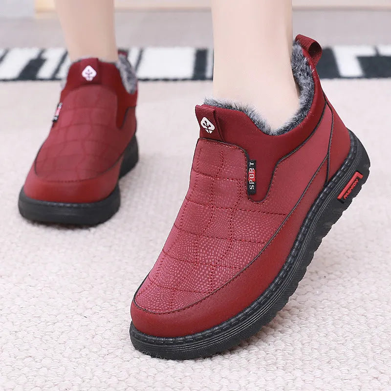 Women's black casual flat ankle boots with round toe and synthetic leather upper on a neutral background.