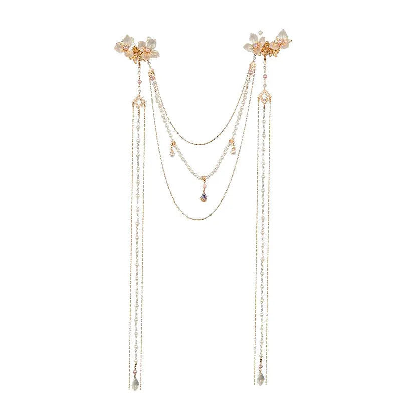 Women's decorative hairpin with pearl, diamond, and flower elements on long tassel with gold grip