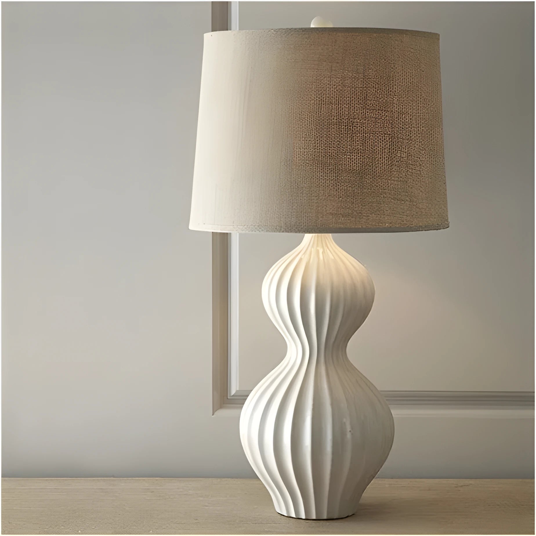 Ceramic base table lamp with fabric shade in country style.