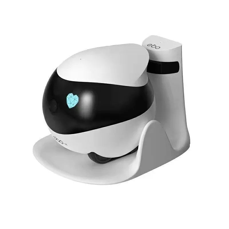 White compact mobile surveillance robot camera on a charging dock.