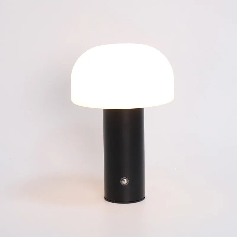 White plastic USB table lamp with integrated charging port on a wooden desk.