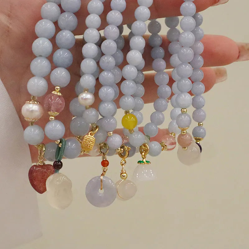Women's gold-plated bracelet with artificial crystal and chalcedony pendant in climbing cat design