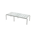 White telescopic plastic storage rack extended to full height with kitchen utensils organised on shelf