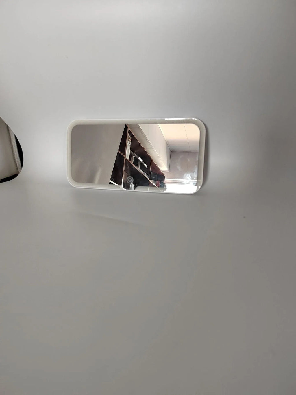 White ABS car sun visor mirror with LED lights and aluminium lens for make-up application.