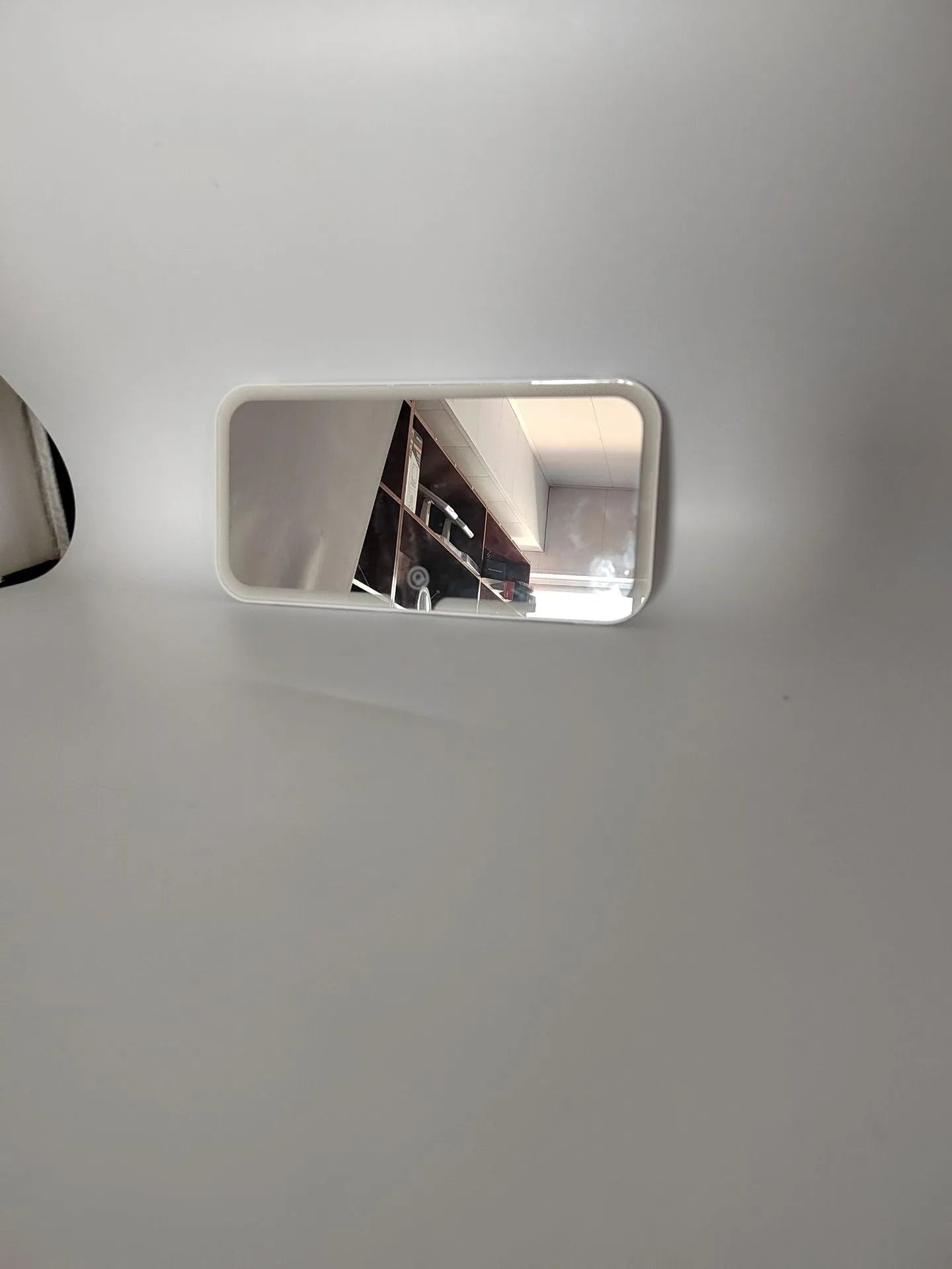 White ABS car sun visor mirror with LED lights and aluminium lens for make-up application.