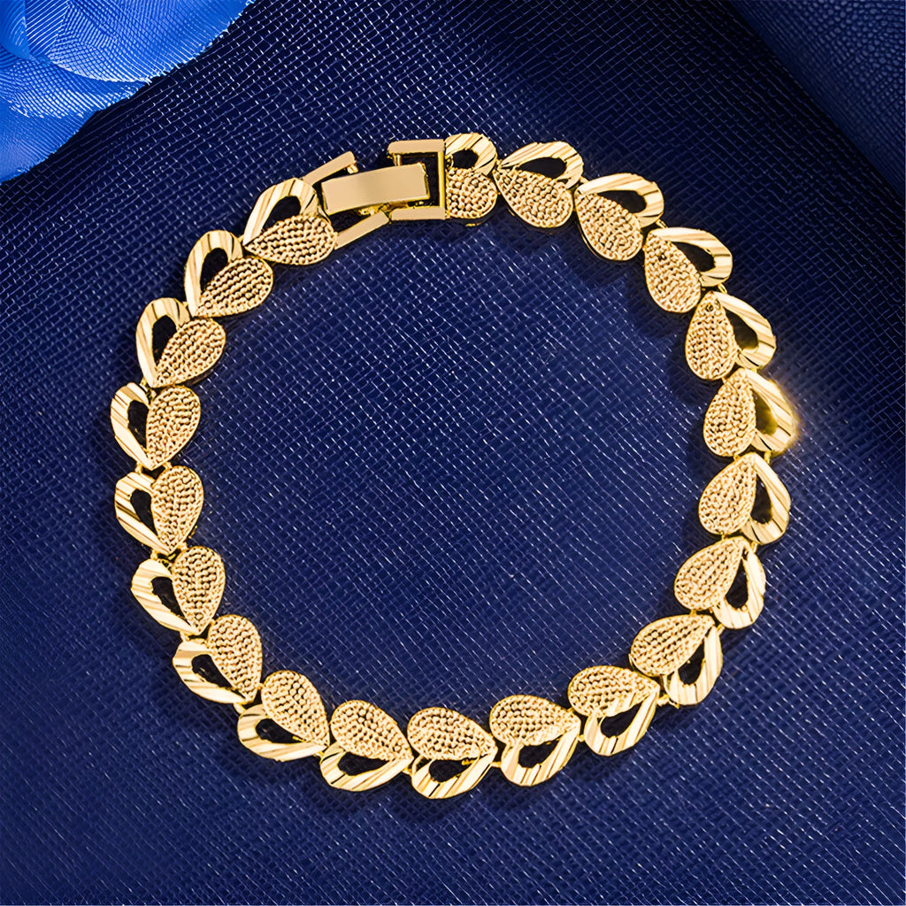 Gold-plated copper heart-shaped bracelet on neutral background showing 18.5cm length