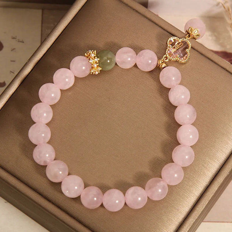 Pink crystal women's bracelet with four-leaf clover pendant and rhinestone details