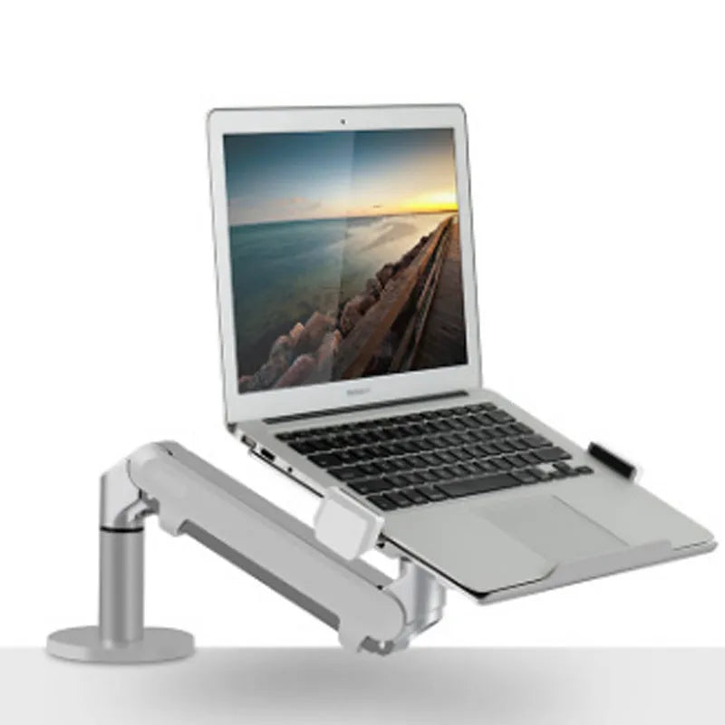 Silver aluminium laptop stand with an adjustable arm bracket on a wooden desk.