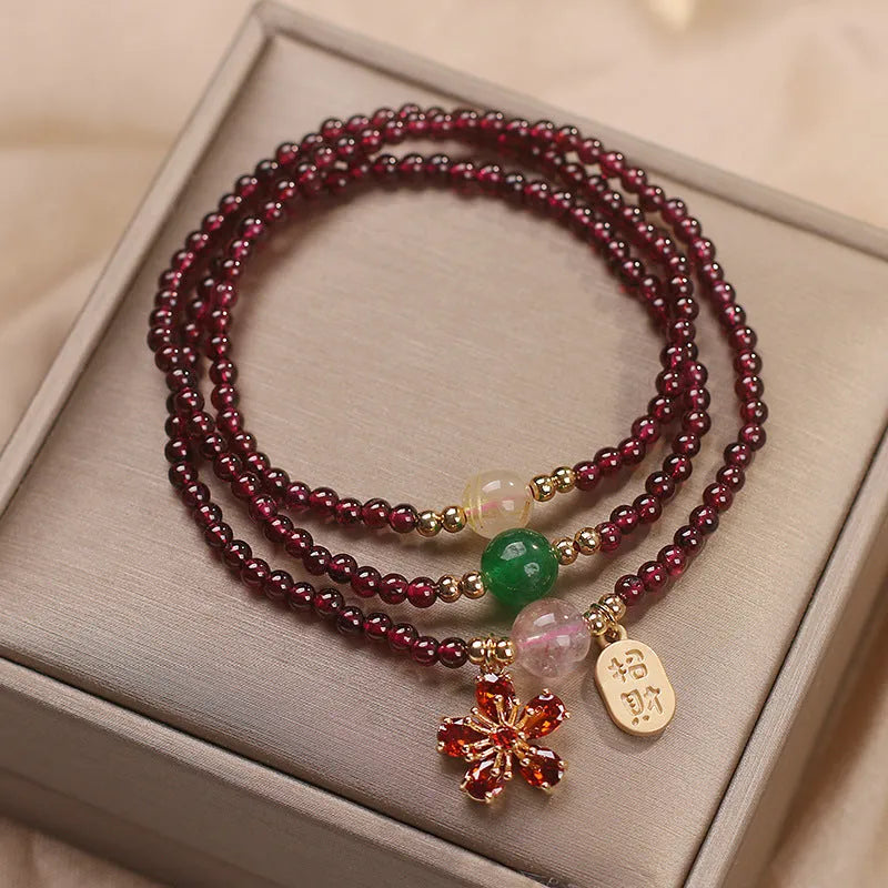 Women's crystal bracelet in pomegranate red cherry blossom colour with simple sequin detail on wrist