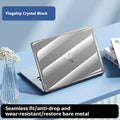 Transparent plastic protective shell case for a MacBook laptop on a table.