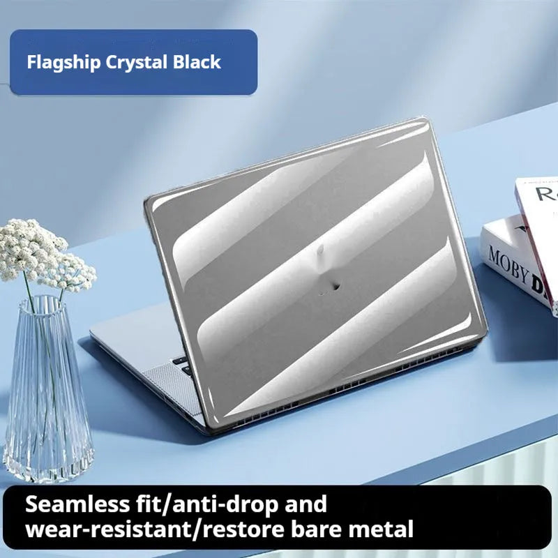 Transparent plastic protective shell case for a MacBook laptop on a table.
