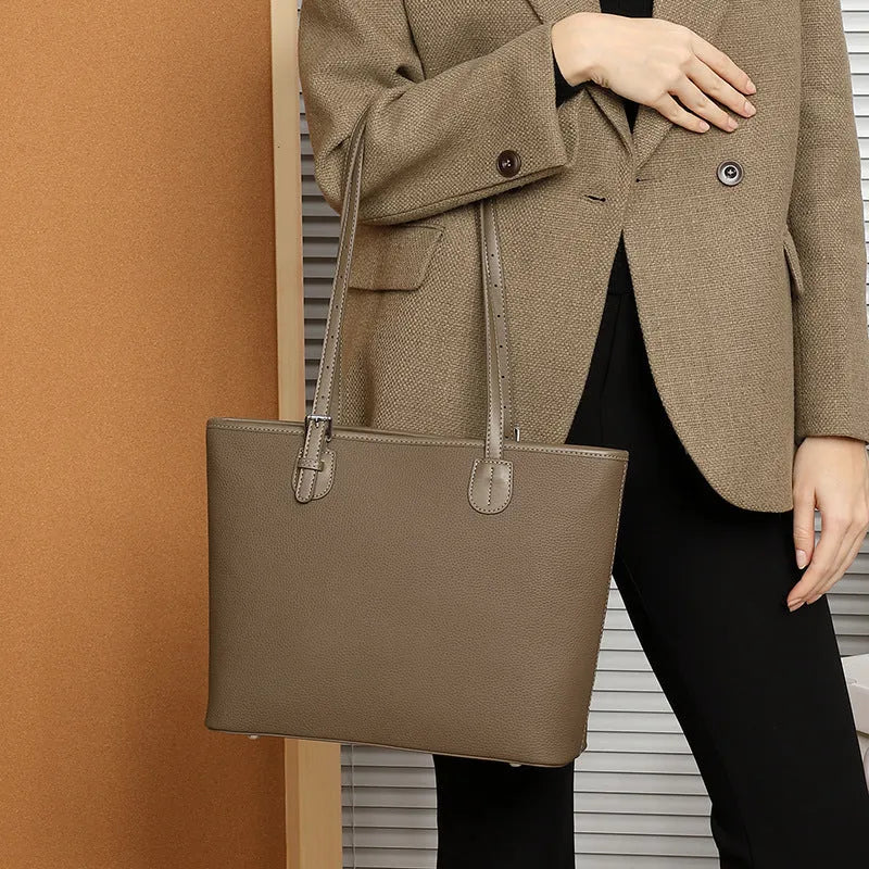 Genuine leather women's tote bag with multiple internal compartments showing document and phone pockets
