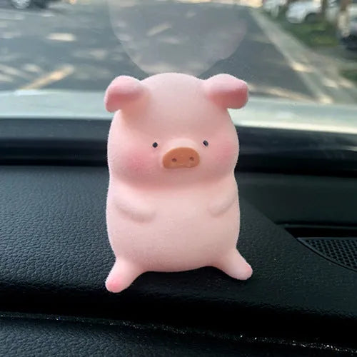 A hard resin cartoon pig car dashboard ornament in one of eight available decorative styles.