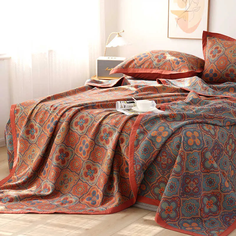 Three-piece cotton gauze bed set with floral plants and flowers pattern, showing blanket and pillowcases.