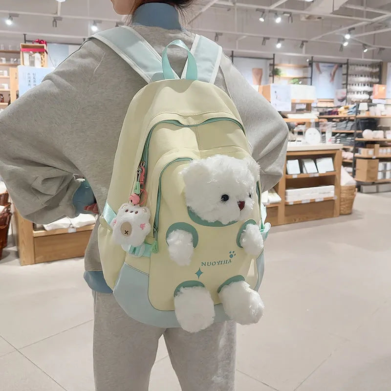 Nylon school backpack in macaron colours with curved shoulder straps and literary style design.