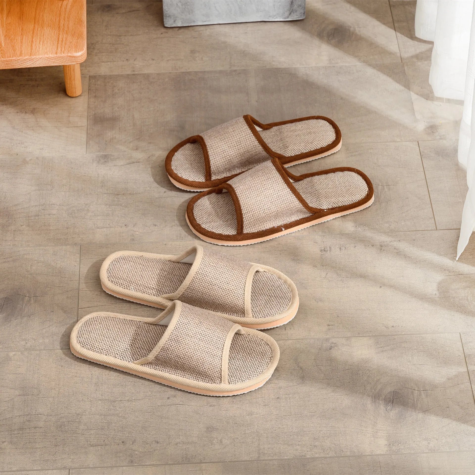 Women's open-toe linen slippers in a light brown colour showing the breathable fabric and thickened sole.