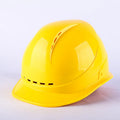 Construction safety helmet in red with adjustable rear hoop and vent holes
