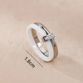 A glossy titanium steel women's double ring with a heart-shaped zirconium inlay, shown in steel white colour.