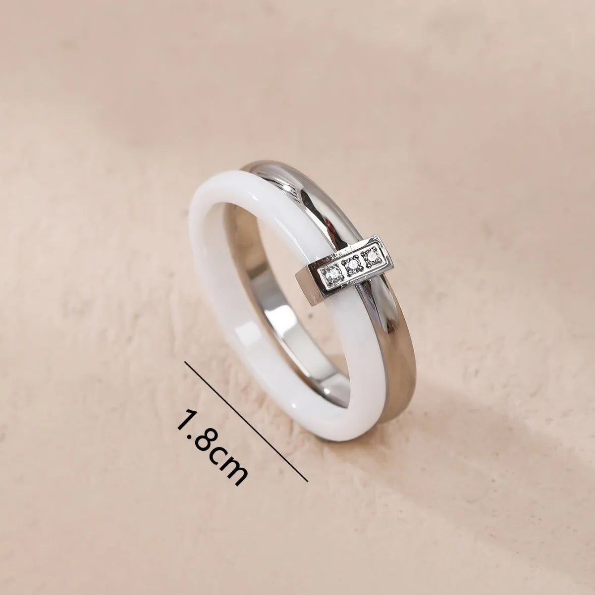 A glossy titanium steel women's double ring with a heart-shaped zirconium inlay, shown in steel white colour.