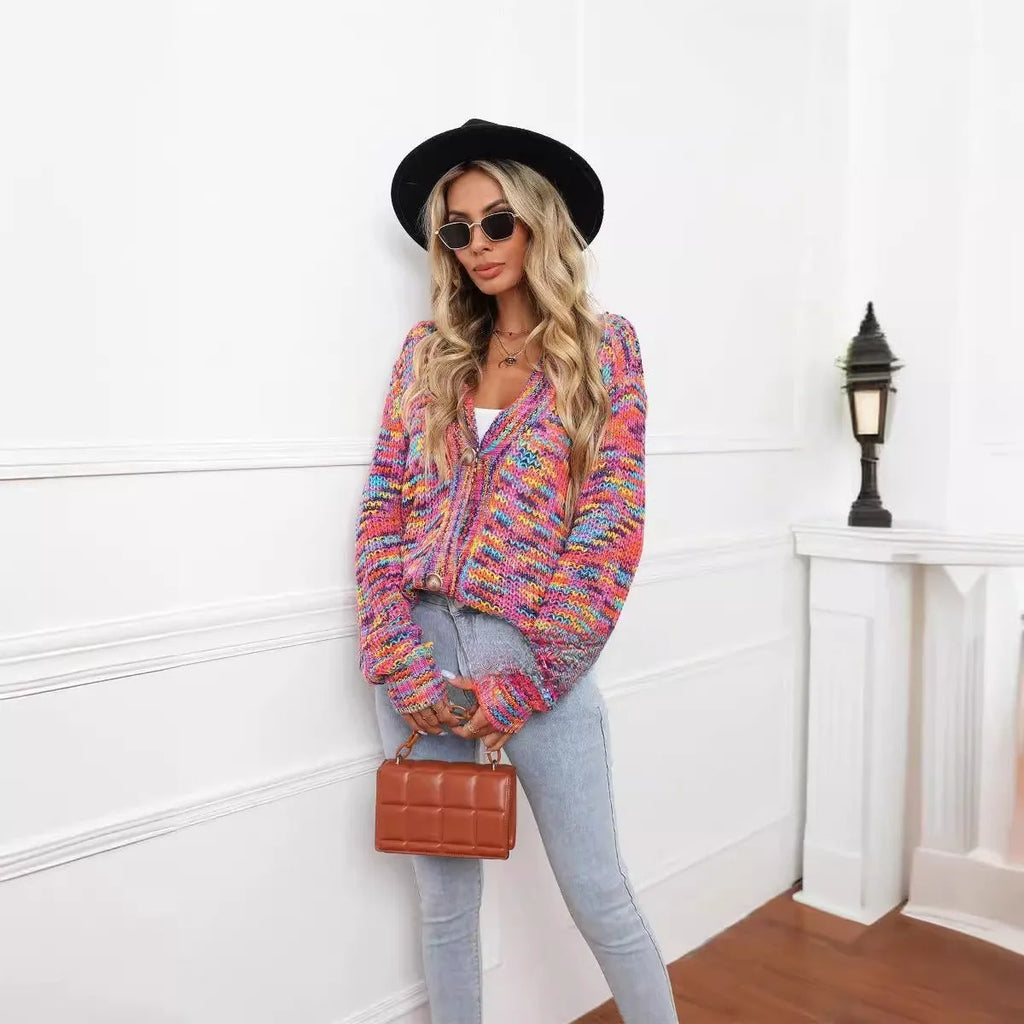 Rose red loose fit short cardigan coat with rainbow striped pattern on a hanger.