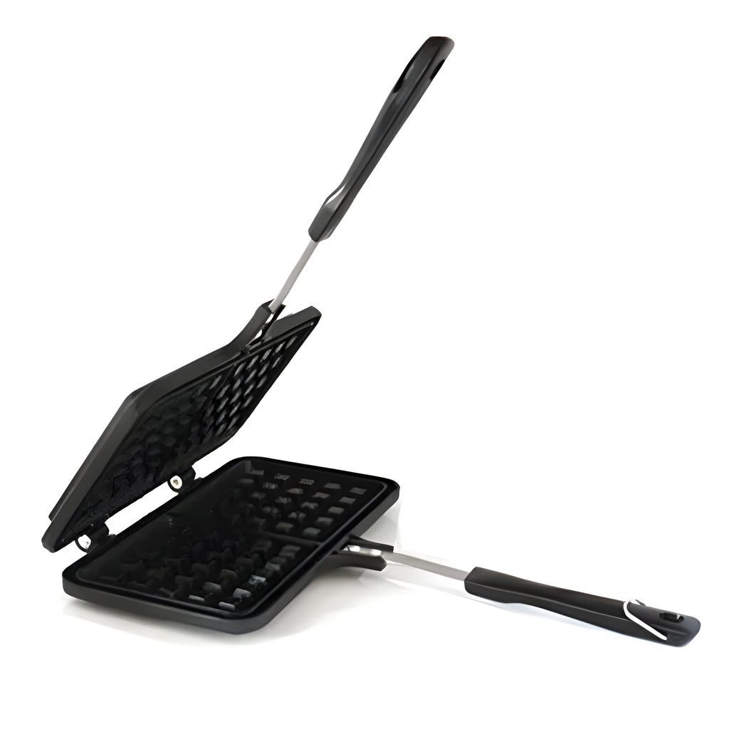 Black aluminium alloy waffle cake mold with nonstick plates and locking handle on gas stove