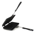 Black aluminium alloy waffle cake mold with nonstick plates and locking handle on gas stove