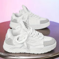 Men's white chunky sneakers with cartoon pattern, thick rubber sole, and front lace-up design on a plain background.