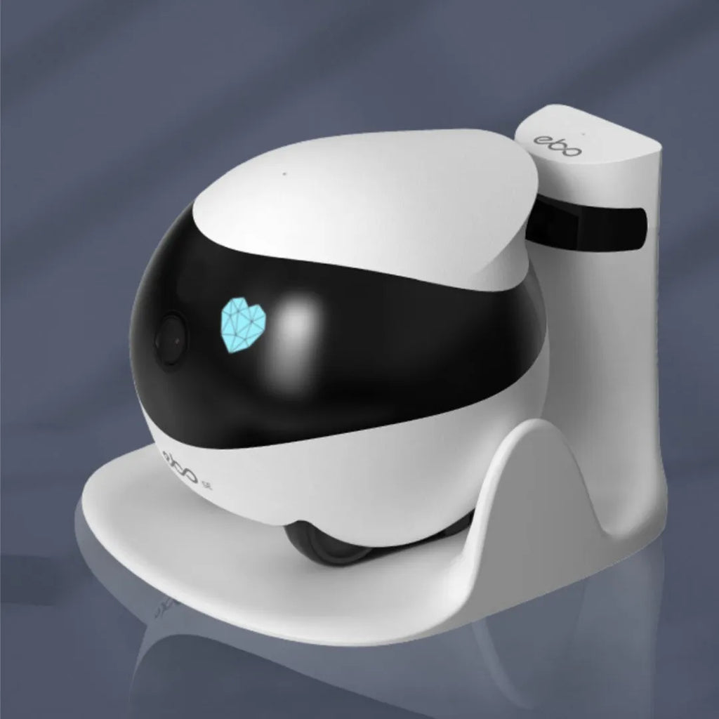 White compact mobile surveillance robot camera on a charging dock.