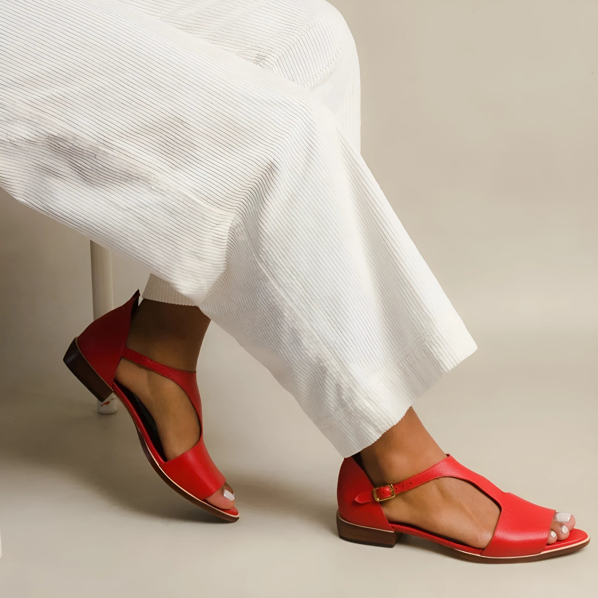 Red women's casual sandals with a square buckle and herringbone toe holder design.