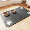 Blue diatom ooze pet feeding mat under dog bowls on wooden floor