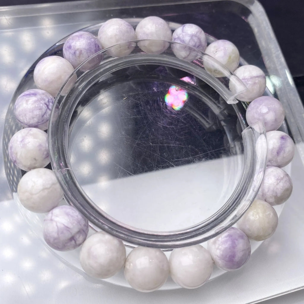 Close-up of a natural purple turquoise beaded bracelet with an adjustable string fastening.