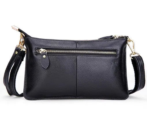 A cowhide lady slant bag in a chosen colour, showing hand and shoulder straps, with dimensions of 24 cm by 14 cm.