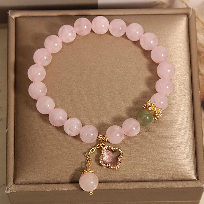 Pink crystal women's bracelet with four-leaf clover pendant and rhinestone details