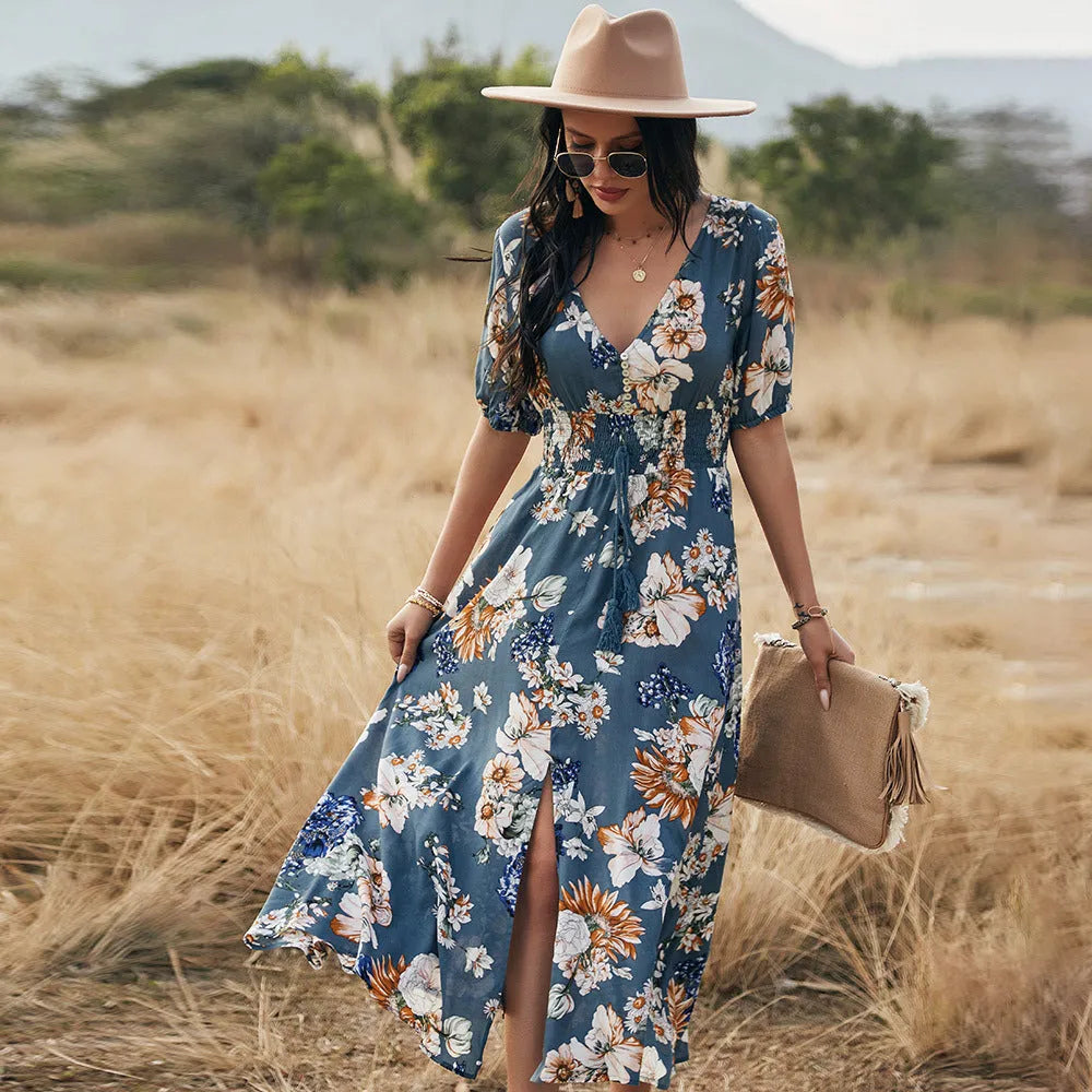 Yellow floral print dress on a hanger showing V-neck, short sleeves, elastic high waist, and full mid-length skirt.