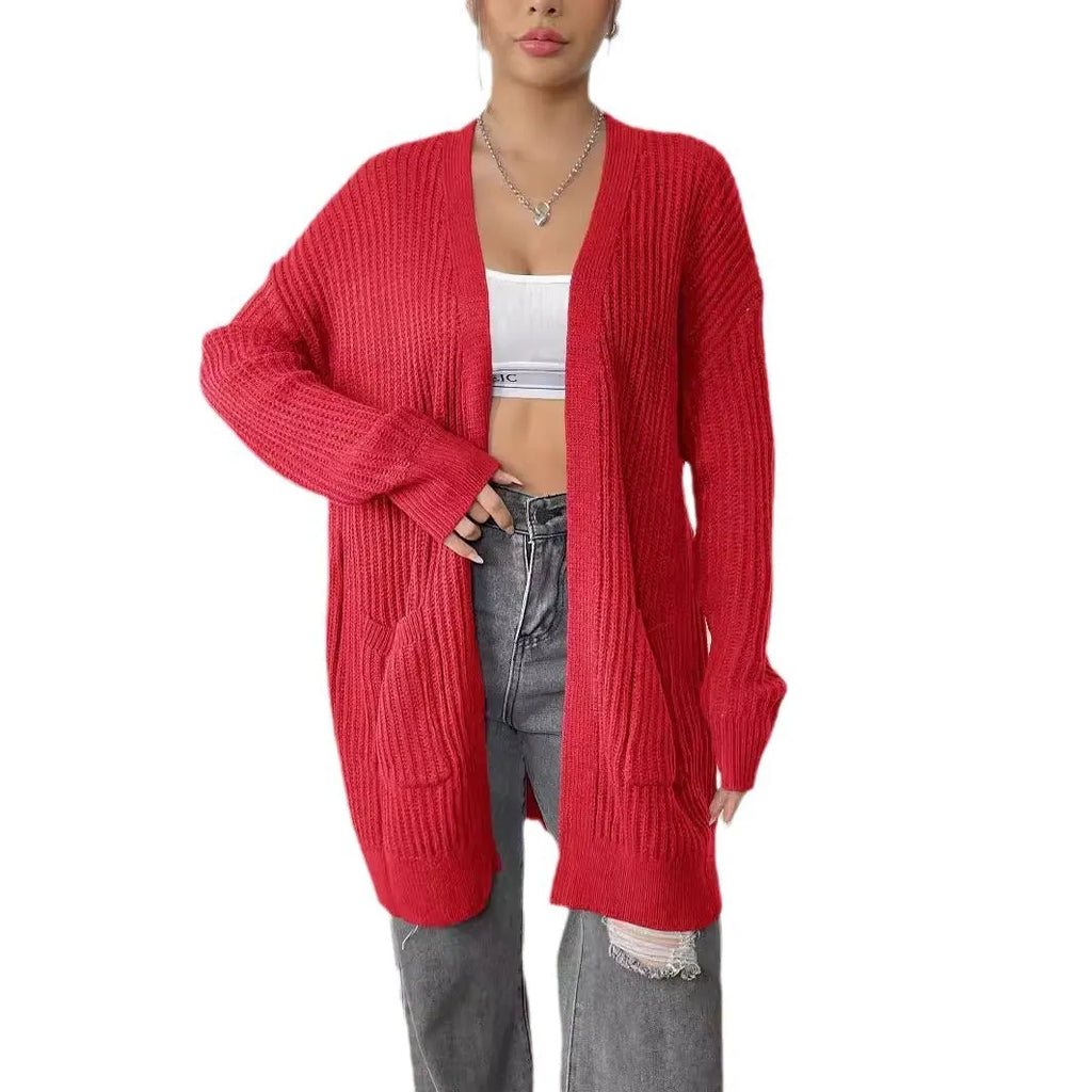 A dark green loose-fit women's cardigan sweater with two front pockets and long sleeves.