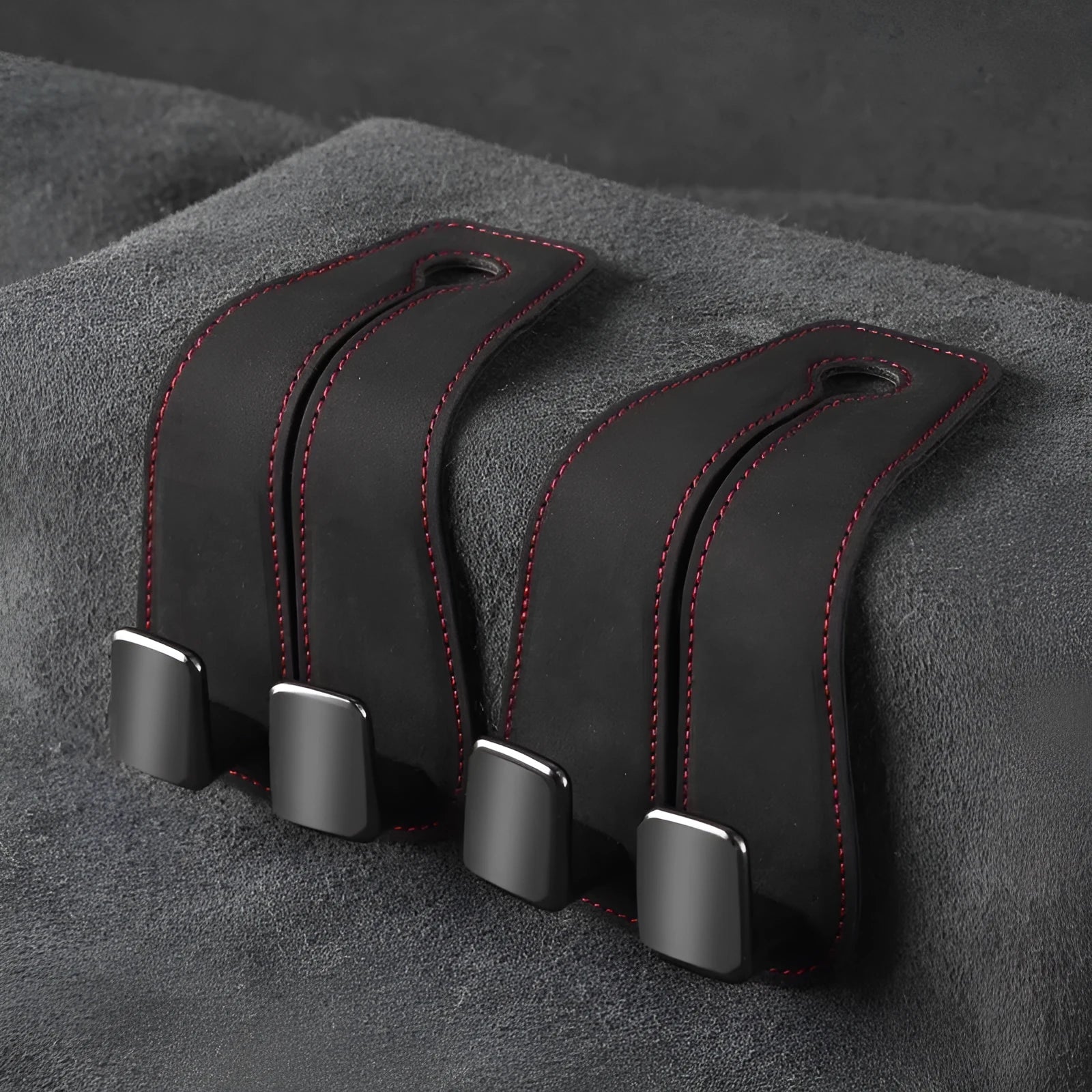 Alloy car seat hook storage bag in black suede fabric shown flipped open and closed on car headrest