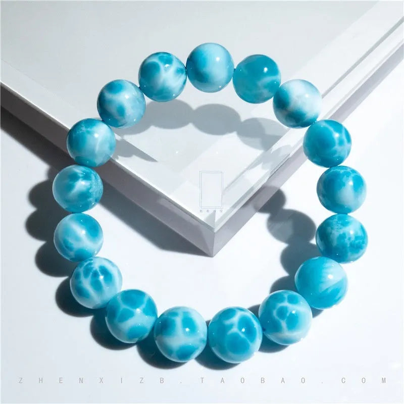 Blue bodhi bracelet with natural sea-pattern crystal stones and a single pearl bead.