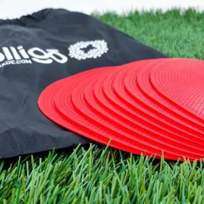 Soft yellow TPE football training target pad flat on grass, 23cm diameter.