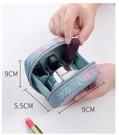 Blue cloth cube-shaped makeup storage bag with a plain pattern on a flat surface.