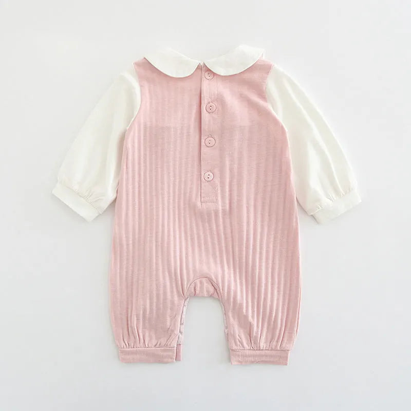 Pink cotton baby girls romper suit with embroidery, long sleeves, and single-breasted closure