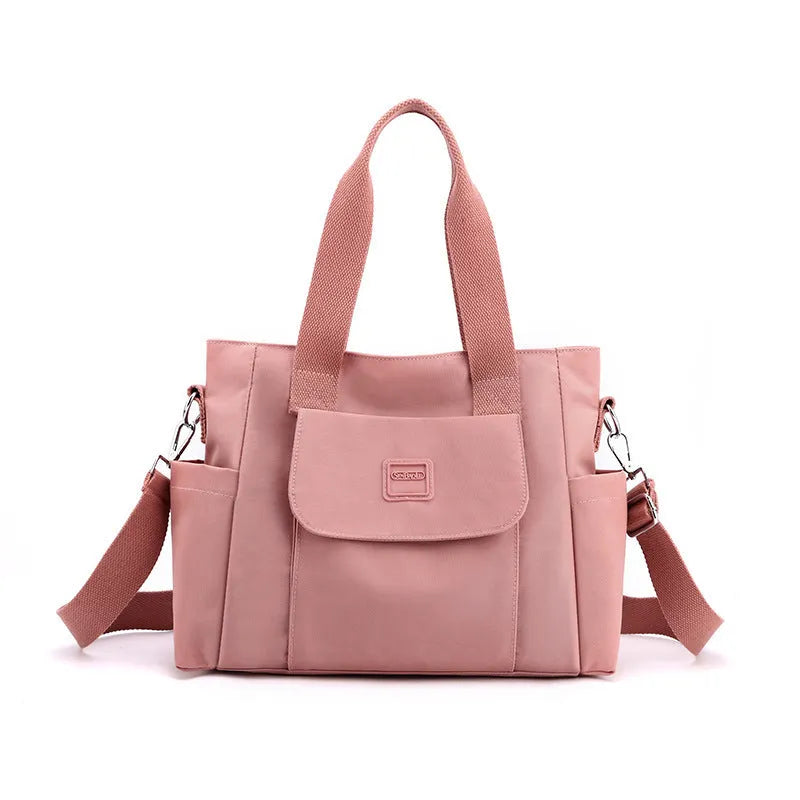 Nylon multi-interlayer shoulder bag in black with single strap and outer sandwich pocket, horizontal square shape