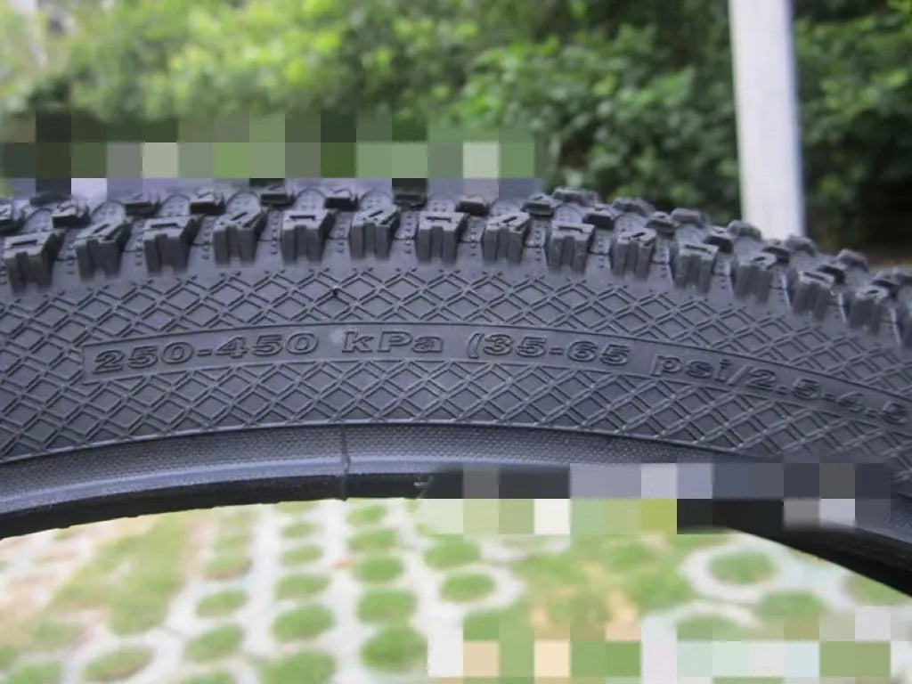 Ultralight black mountain bike tyre with white label option, showing tread pattern and size markings.