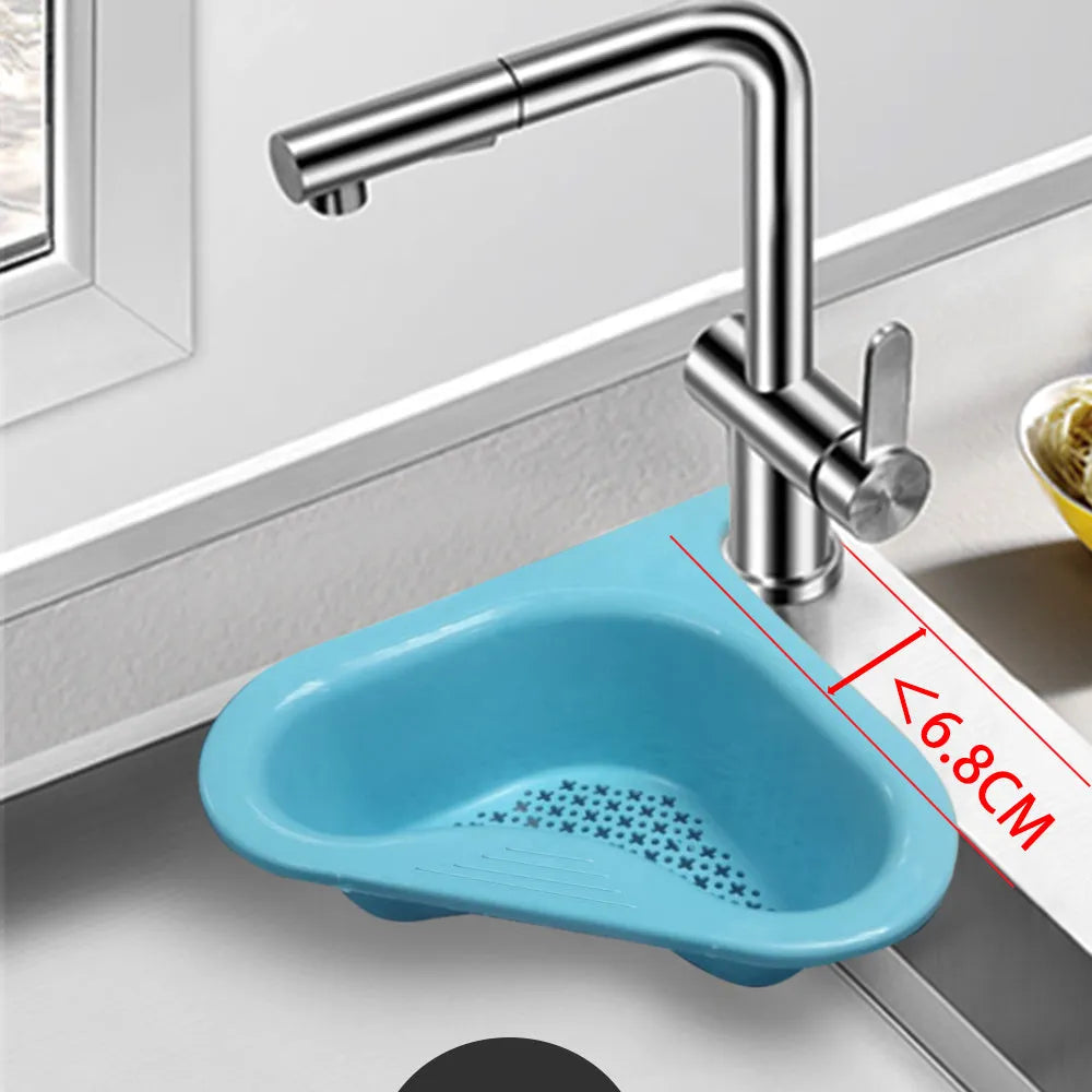 Blue plastic swan-shaped basket hanging over a kitchen sink edge to drain fruit and vegetables.