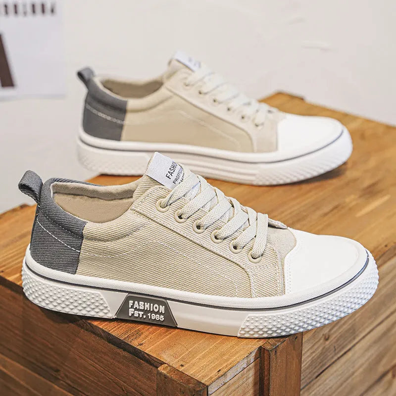 Men's blue low-top canvas skateboard shoes with round toe and white lace-up front.