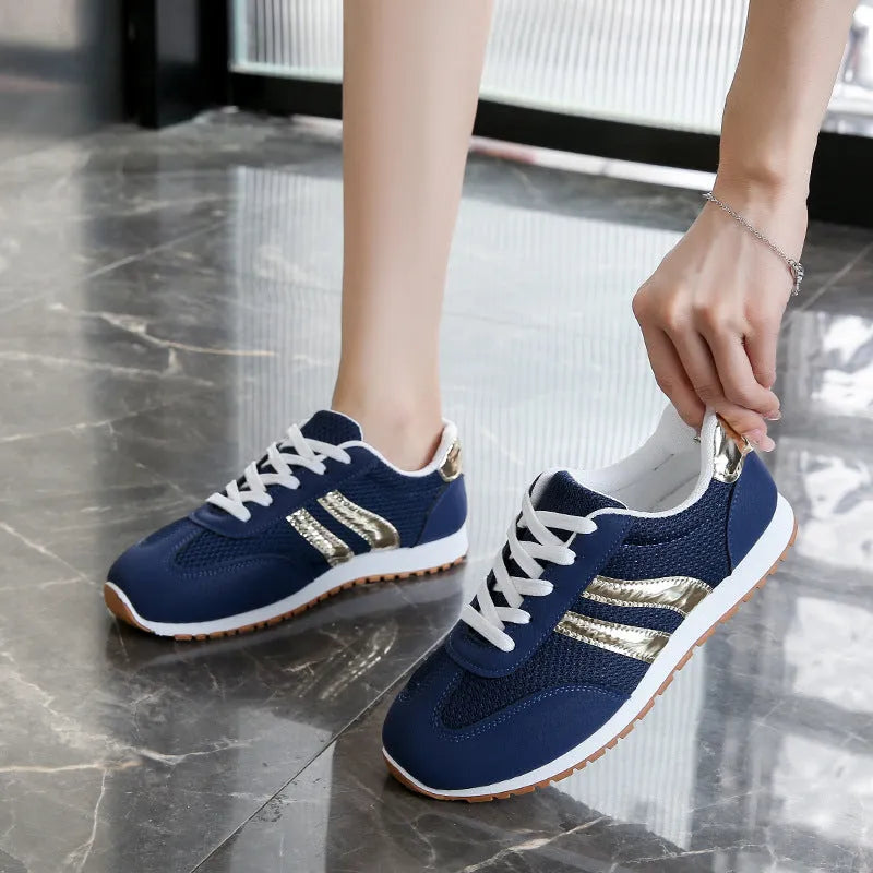 Blue women's lace-up tennis shoes with cross shoulder straps and a round toe