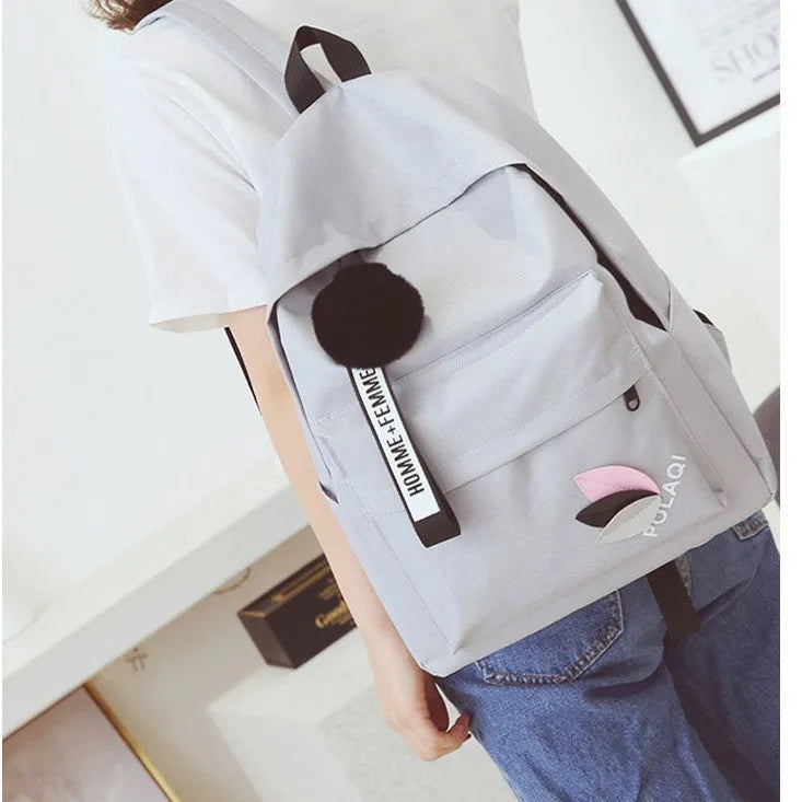 College style canvas backpack in green with leaf pattern, showing 40cm height and organisational compartments